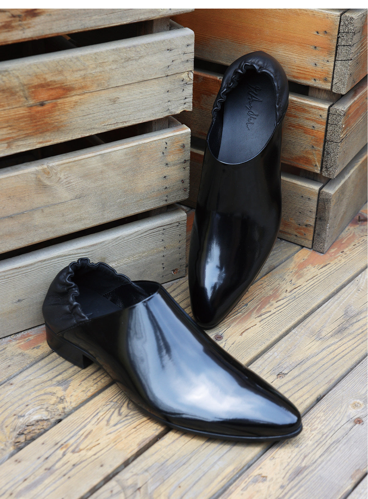 Split‑edge cowhide pointed‑toe black mirror mules