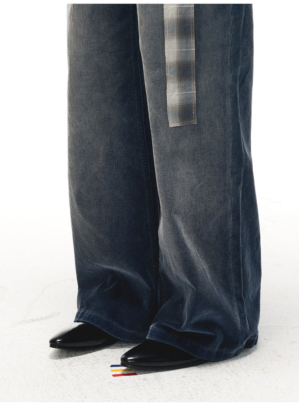 Split‑edge cowhide pointed‑toe black mirror mules