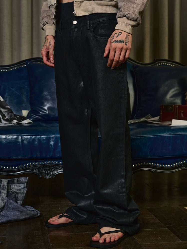Coated distress bootcut jeans